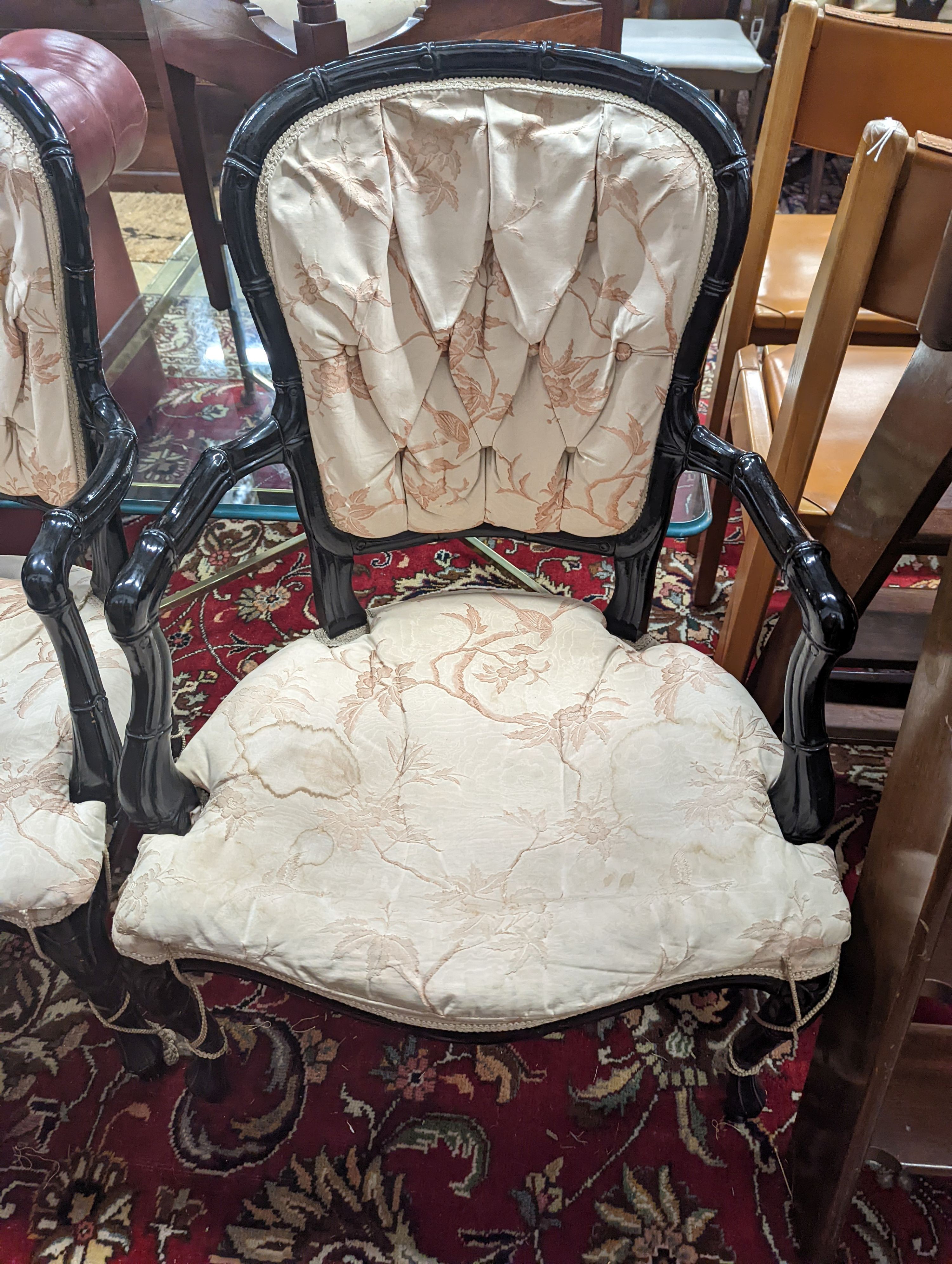 A pair of ebonised simulated bamboo open armchairs, width 59cm, depth 54cm, height 90cm